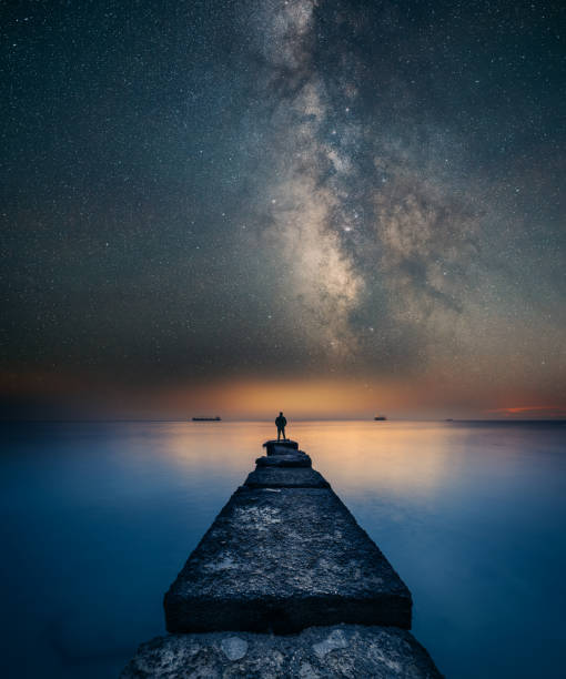 Man standing under the Milky Way Landscape stock photo