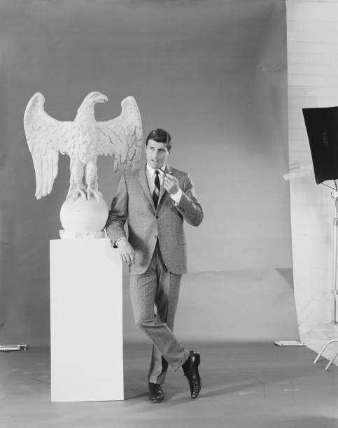 Man standing with smoke pipe besides eagle statue  1964 stock pictures, royalty-free photos & images