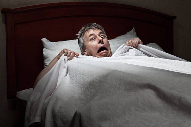 Man startled awake by intruder stock photo