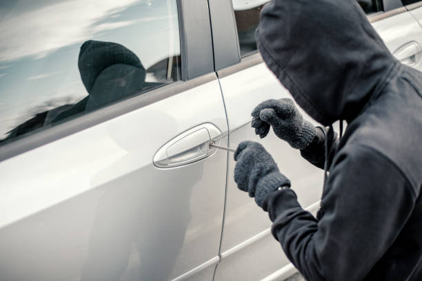 Man stealing a car Man stealing a car burglary stock pictures, royalty-free photos & images