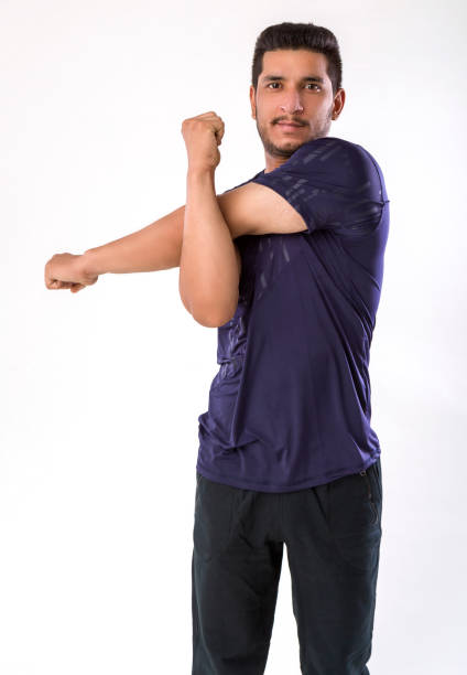 man stretching his arms after shoulder exercise
