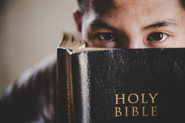 man student reads a holy stock photo