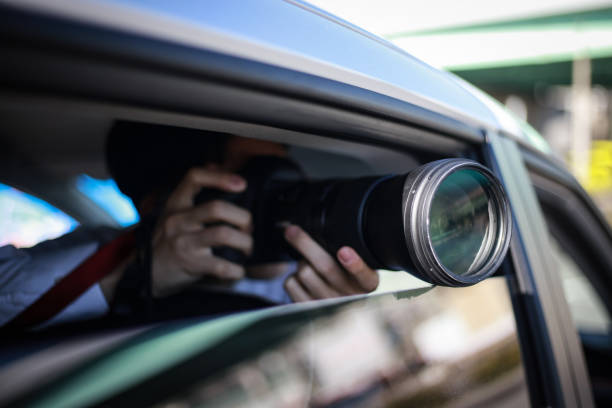 A man taking a picture from inside the car stock photo