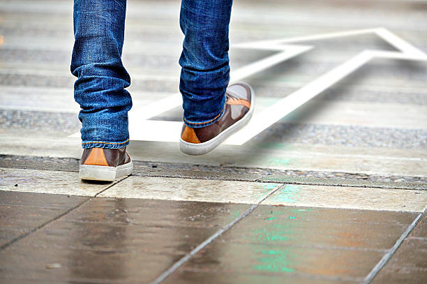 Man taking the step in the right direction stock photo