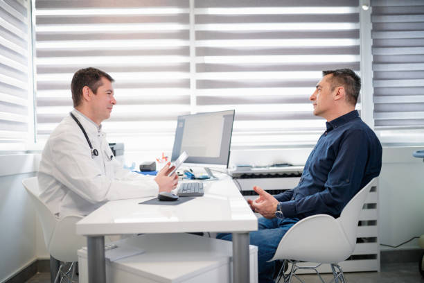 Man talking to doctor on consultations stock photo
