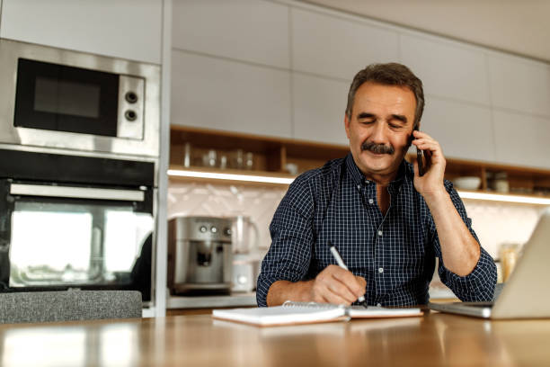 Man talking with someone over the phone. stock photo