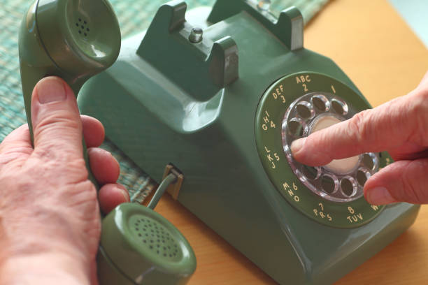 Man uses old rotary phone stock photo
