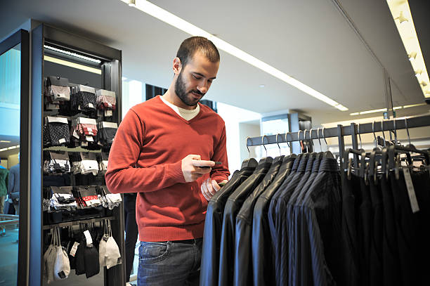 Man Using Barcode Reader Through Smart Phone stock photo