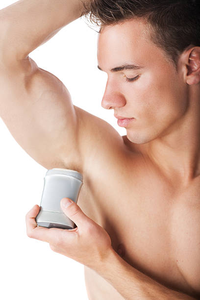 mann mit deodorantstift nach dusche - marko skrbic stock-fotos und bilder