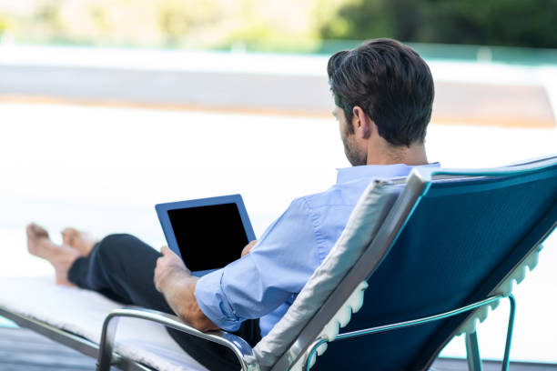 Man Using Digital Tablet Near Pool Stock Photo More