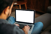 istock Man Using Laptop Blank Screen at Home 1302084694