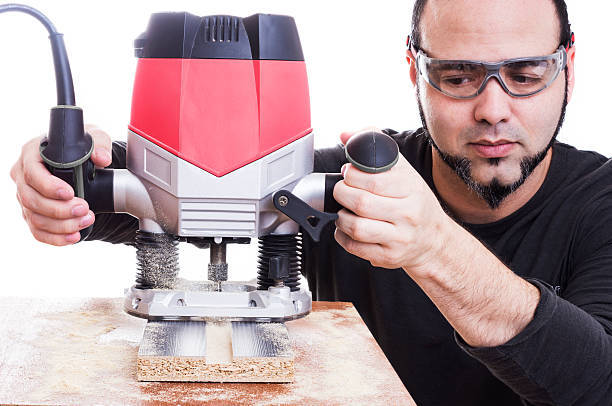 Man using plunge router stock photo
