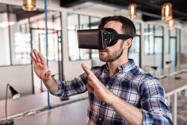 Man using virtual reality glasses in startup office. stock photo