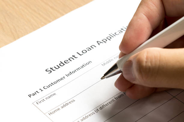 Man wait to fill information in student loan application form on desk background Man wait to fill information in student loan application form on desk background student loan forgiveness foreigh stock pictures, royalty-free photos & images