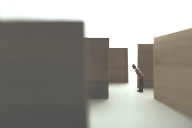 man walking in a complex maze looking for exit stock photo