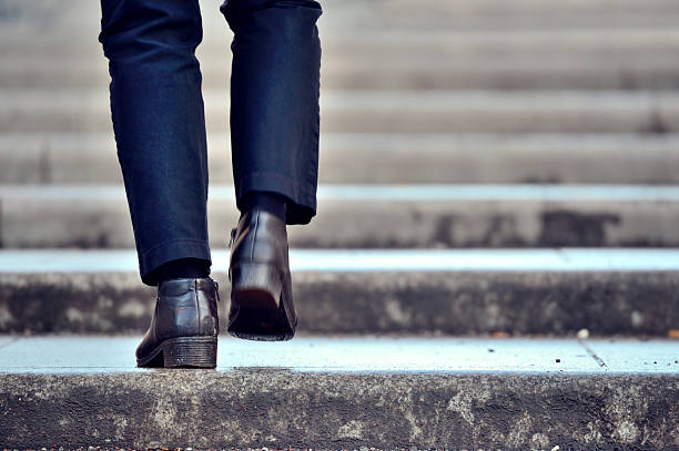 Man walking up the stairs stock photo