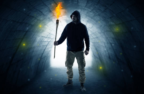 Silhouette Of A Man With A Flashlight On A Dark Tunnel Stock Photos ... Silhouette Man Walking Tunnel