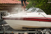 istock A man washes a motor yacht with a jet of water at a boat station, close-up 1388301011