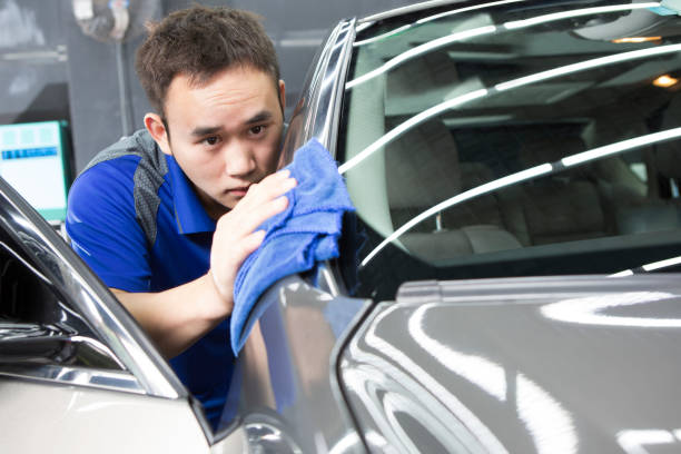 man washing car with a cloth stock photo
