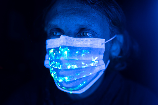 Man wearing  protective face mask with uv light