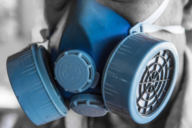 Man wears a blue chemical mask close up stock photo