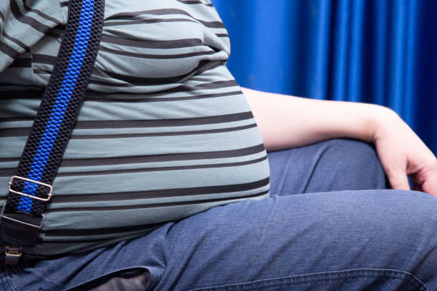 A man with a big belly. Obesity. stock photo