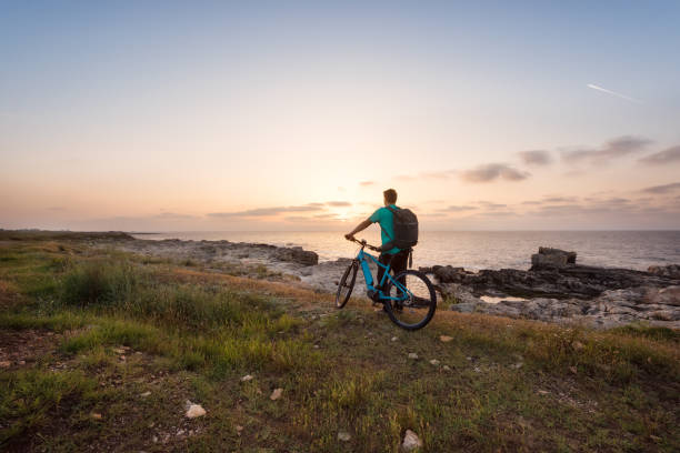 Man with a bike in the nature stock photo