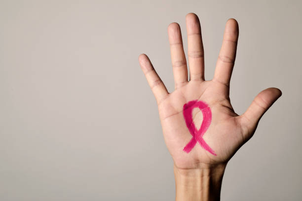 man with a pink ribbon for the breast cancer stock photo