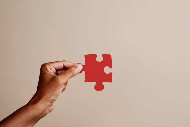 man with a red puzzle piece stock photo