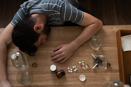 man with addictions asleep surrounded by drugs picture id1286432590?b=1&k=6&m=1286432590&s=170667a&w=0&h=1tndgKXeNPGonEpT8I urconUIS OJe9oPb1y3fA7Gk=