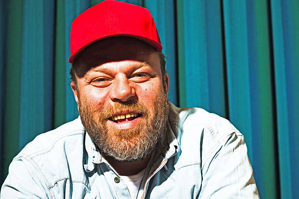 Man with beard and red cap. Portrait of a trucker. stock photo