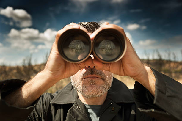 Man with  binoculars stock photo