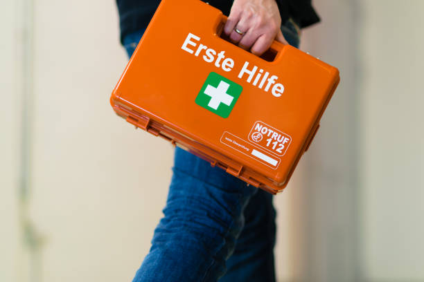 Man with first aid kit runs to help stock photo