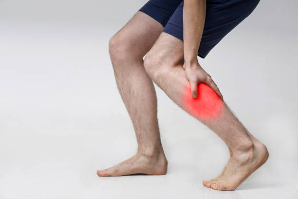 Man with injured calf, massaging painful leg muscle Man with injured calf, massaging painful leg muscle with red sore spot acute angle stock pictures, royalty-free photos & images