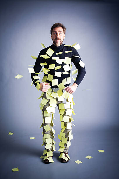 Man with Mustaches Ejecting Post-it Notes stock photo