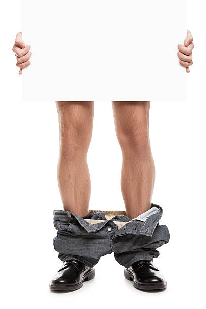 Man with pants down holding blank placard stock photo