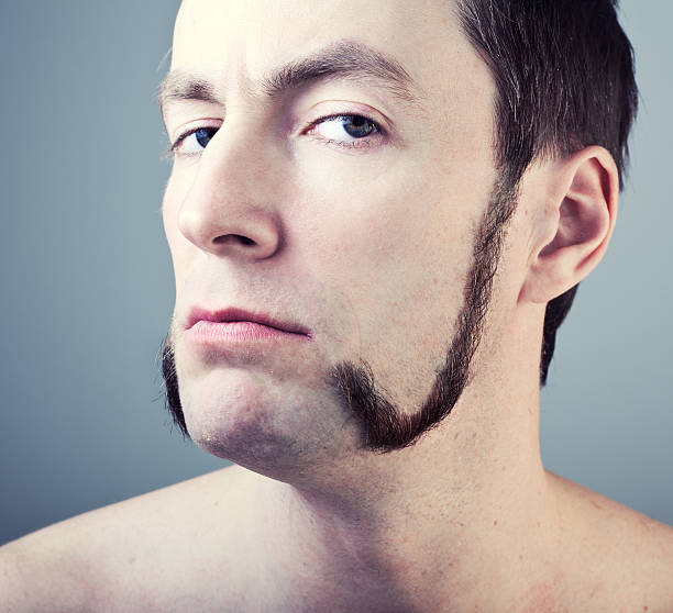 man with sideburns man with sideburns close-up photo mutton chops stock pictures, royalty-free photos & images