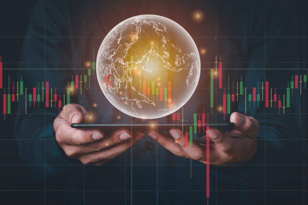 A man with tablet and a hand holding a globe graphic and stock chart Investment concepts, business concepts, technology concepts. A man with tablet and a hand holding a globe graphic and stock chart Investment concepts, business concepts, technology concepts. stock market  stock pictures, royalty-free photos & images
