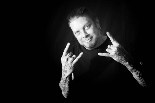 Man With Tattoos Holding Hands Up Black and White stock photo