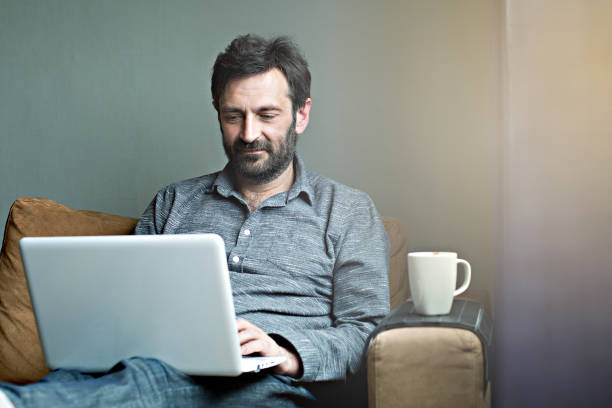 Man working on laptop stock photo