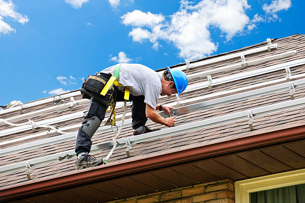 man working on roof installing rails for solar panels - dakdekker stockfoto's en -beelden
