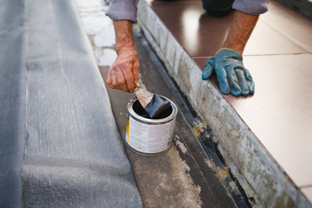 man working with waterproofing material, close-up view stock photo