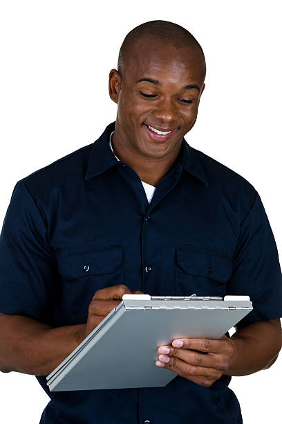 Man writing an estimate Blue collar worker writing up an estimate  african american plumber stock pictures, royalty-free photos & images