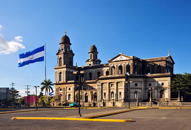 Managua, Nicaragua: Old Cathedral and Nicaraguan flag stock photo