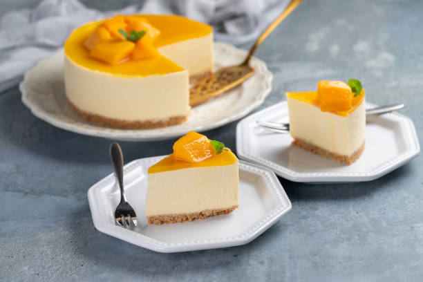 Mango cheesecake on white plate stock photo