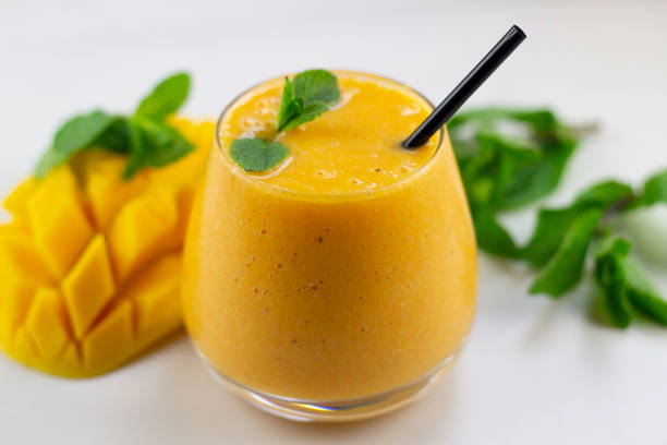 Mango Smoothie fresh and delicious mango smoothie -- healthy eating mango smoothie stock pictures, royalty-free photos & images