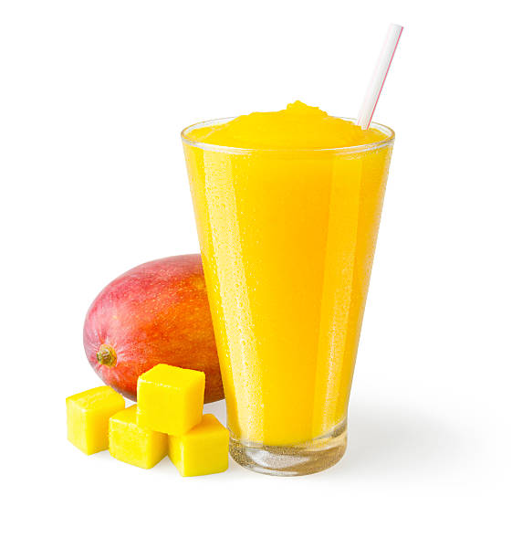 Mango Smoothie with Garnish on White Background A mango smoothie in a generic glass on a white background with a garnish of mangos on the side. mango smoothie stock pictures, royalty-free photos & images