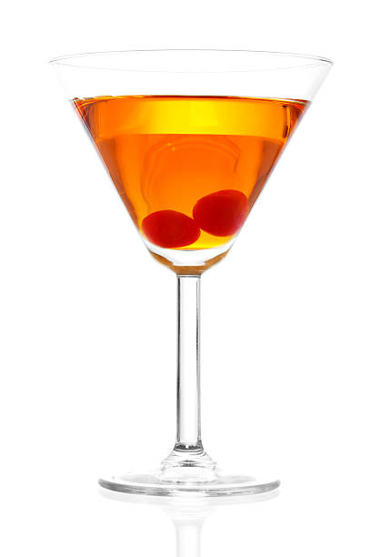 Manhattan Cocktail Stock image of Manhattan cocktail on martini glass with Maraschino Cherries over white background manhattan cocktail stock pictures, royalty-free photos & images