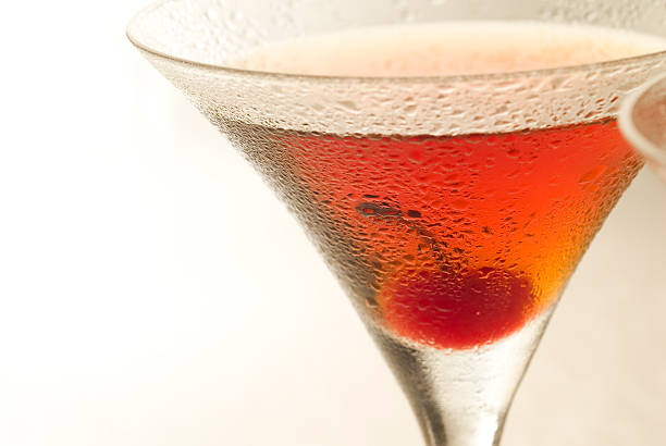 Manhattan cocktail Manhattan cocktail Close up with cherry. See other Drinks and Cocktails...See other Drinks and Cocktails...http://i1215.photobucket.com/albums/cc503/carlosgawronski/CocktailsandDrinks.jpg manhattan cocktail stock pictures, royalty-free photos & images