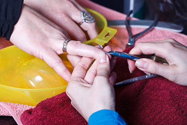 Manicure master at work. Close-up of beautician preparing customers...